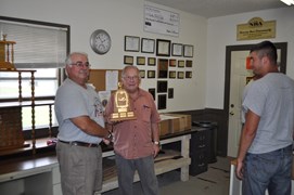 Tommy Thompson receiving the L.E. Ferguson Trophy for Rapid Fire Aggregate from Denny Couler, club President (R)