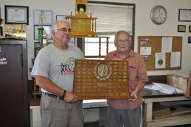 Denny Coulter, club President (R) presenting the Atkin Trophy for the ND State High-Power Championship to Tommy Thompson (L)